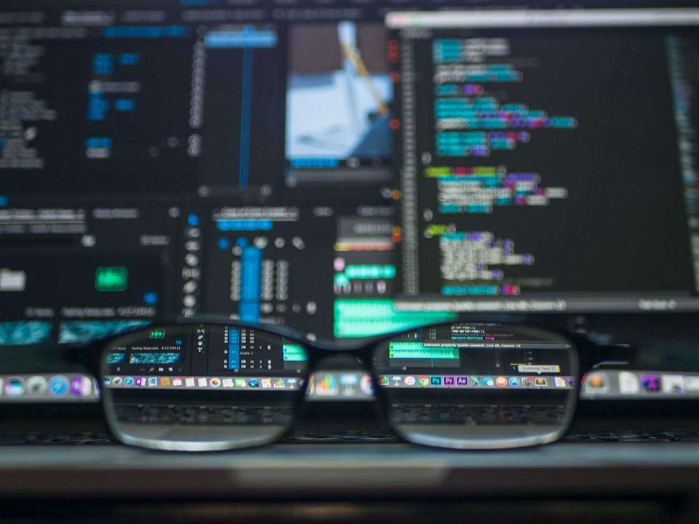 Code reflected through glasses — precision engineering